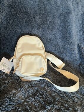 lululemon athletica Satin Mini Sling Bag in Cream with Gold Hardware